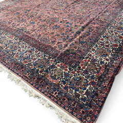 Early 20th Century Kerman Lavar Persian Rug, Hand-Knotted in Iran. Rose Field w/ Ivory Border Accented in Blue and Green. Fine Wool Pile on Cotton Foundation. Classic Overscale Room Size. Measures 11.06Lx19.01W. Circa 1920s.