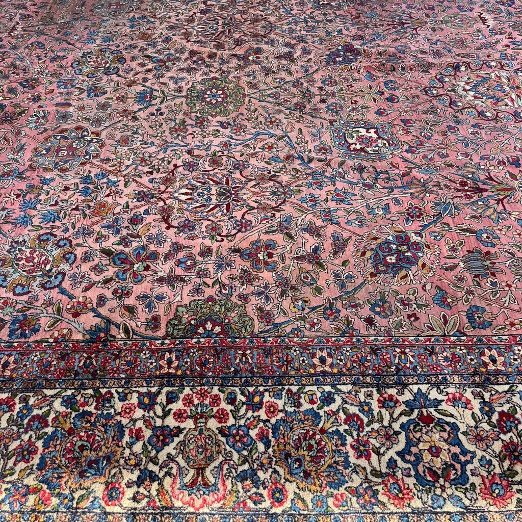 Early 20th Century Kerman Lavar Persian Rug, Hand-Knotted in Iran. Rose Field w/ Ivory Border Accented in Blue and Green. Fine Wool Pile on Cotton Foundation. Classic Overscale Room Size. Measures 11.06Lx19.01W. Circa 1920s.